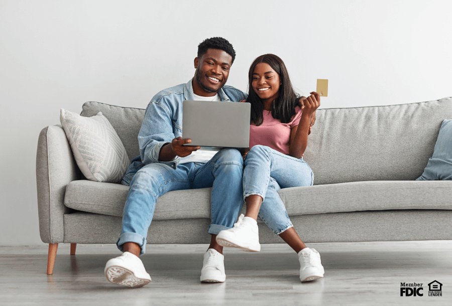 a couple applying for a secured credit card through online banking