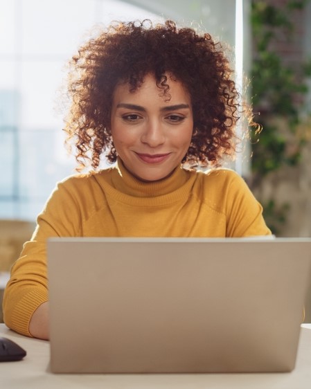 a woman processes bill pays with online banking