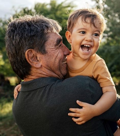 a grandfather hugs his grandson