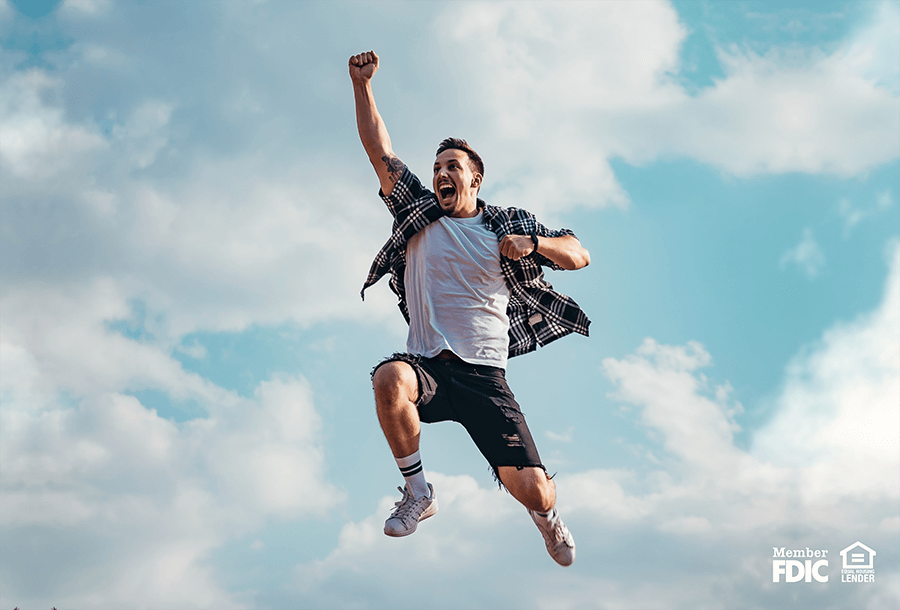 a man jumps into the air celebrating his mastery of money