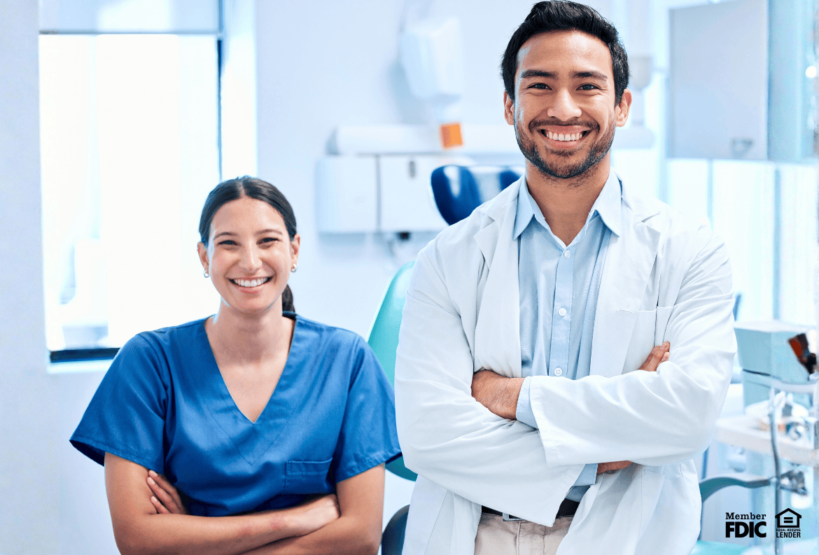 Dentist team smiling because they qualify for the Premier Choice Mortgage Program for dentists.