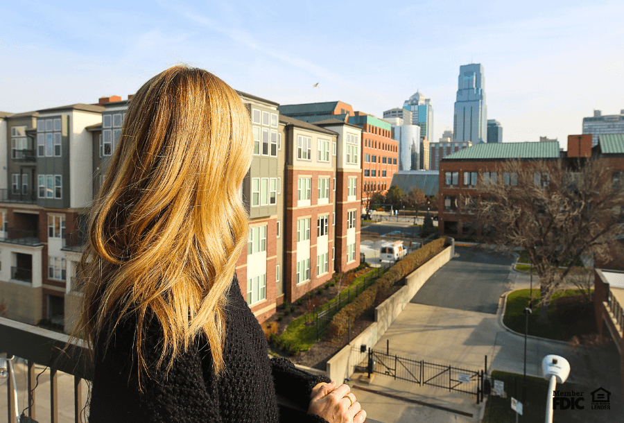 a woman stands on a roof in River Market looking out over downtown Kansas City