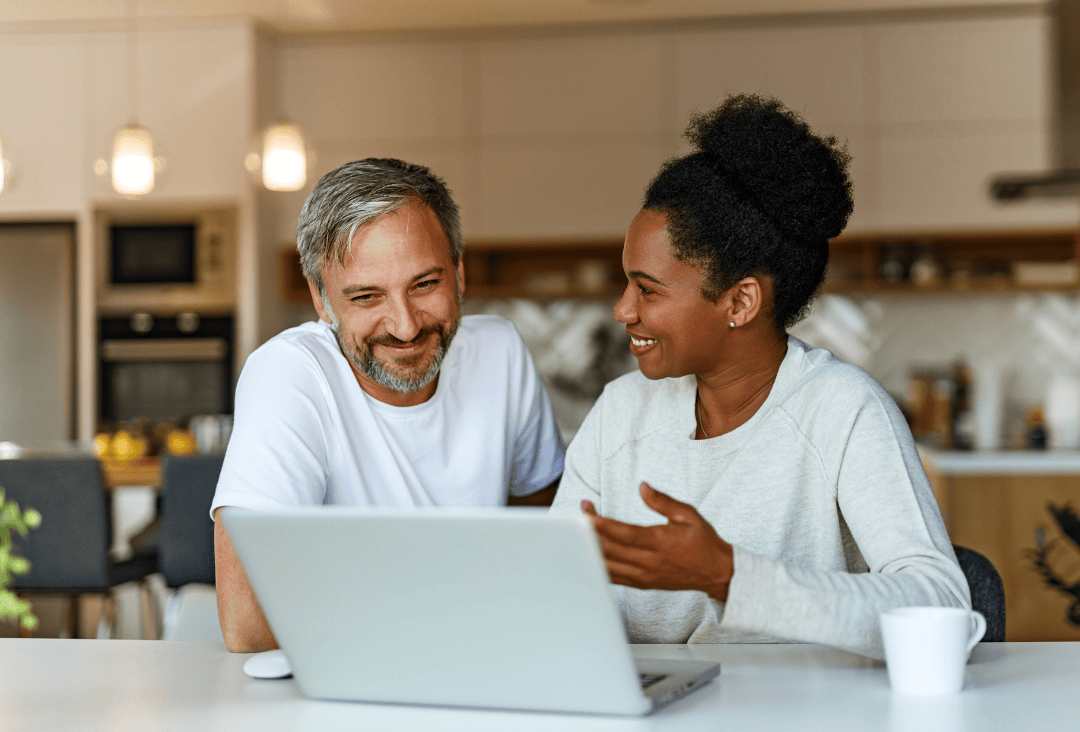 Couple at home learning how to get free credit report from Equifax annually.
