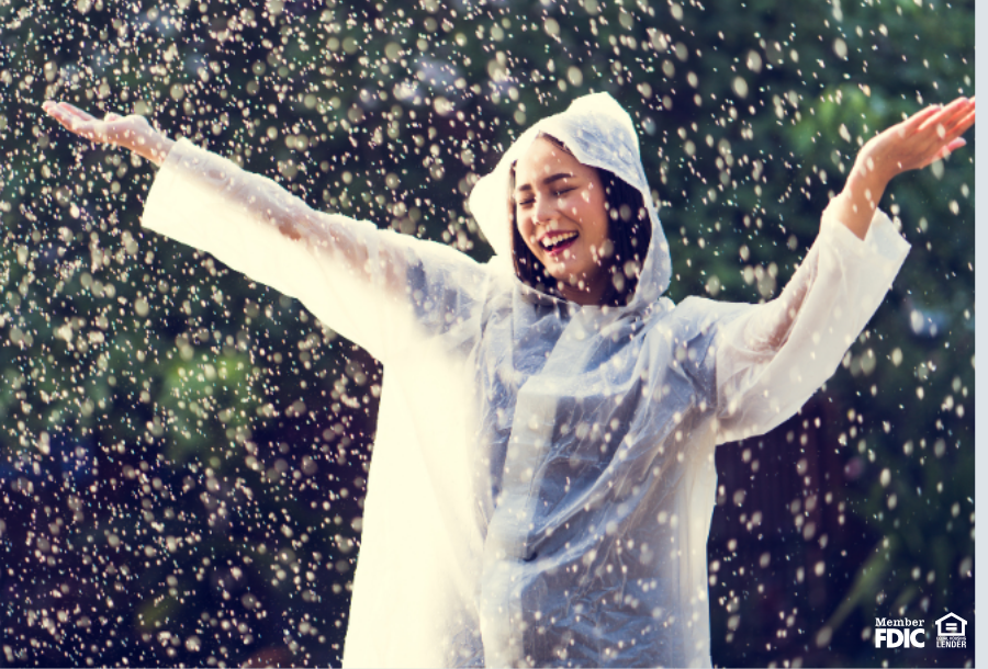 a woman outside enjoying a rain storm