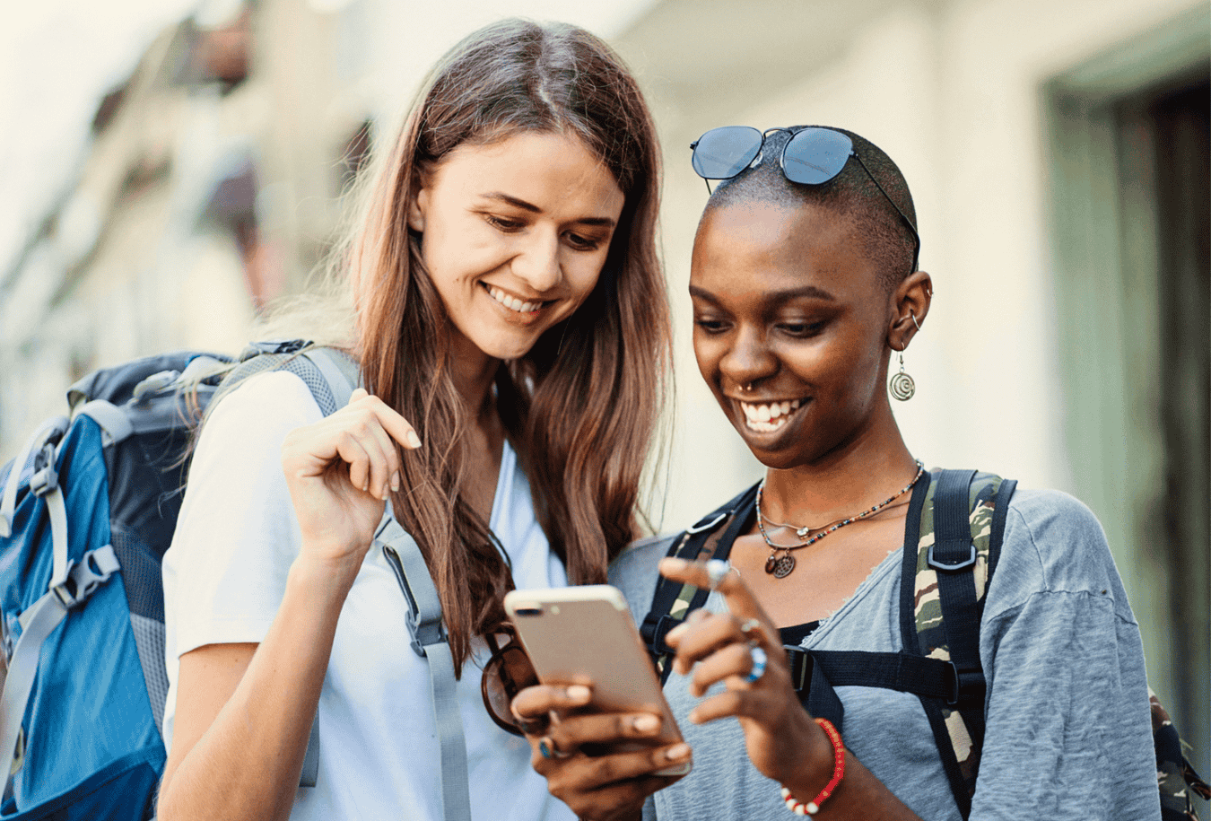 Two friends backpacking through Europe, checking their online bank accounts.