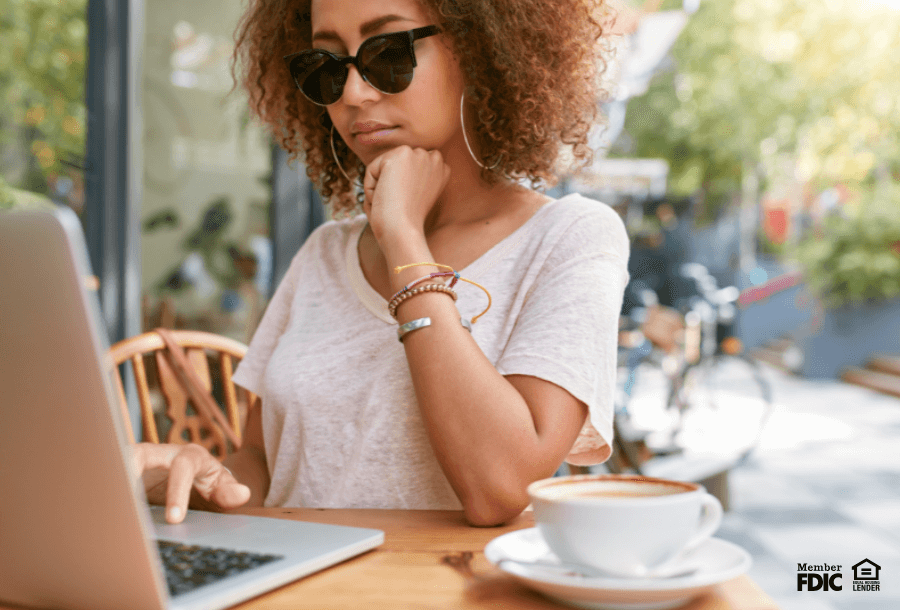 a young woman works on her laptop at a cafe