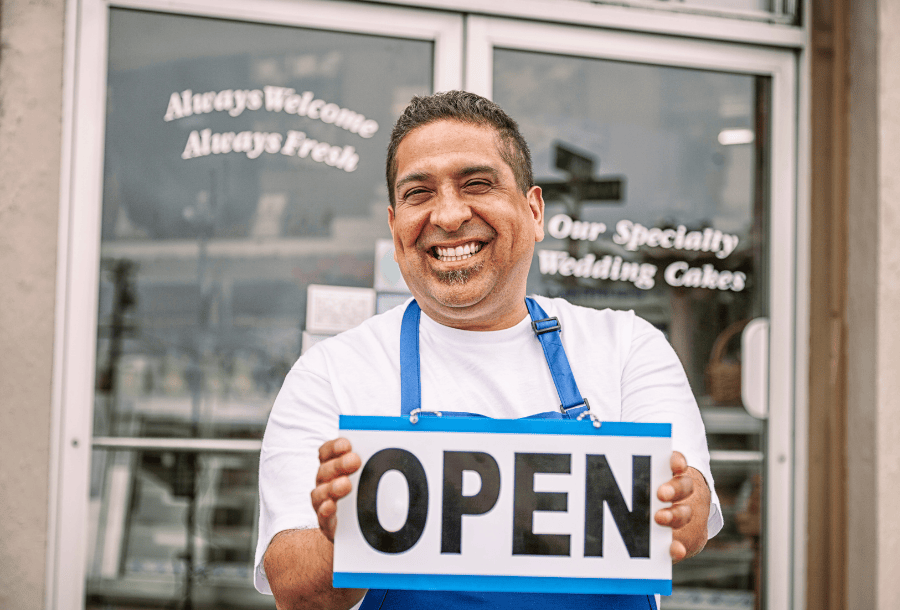 Small business owner holding an 