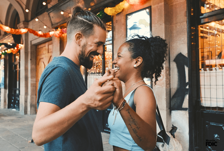 a couple dances on the sidewalk together