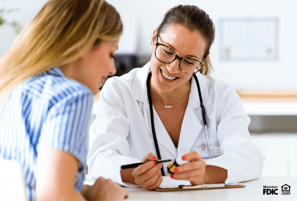 Doctor discussing patient care, while also feeling happy she found the best mortgage program for doctors.