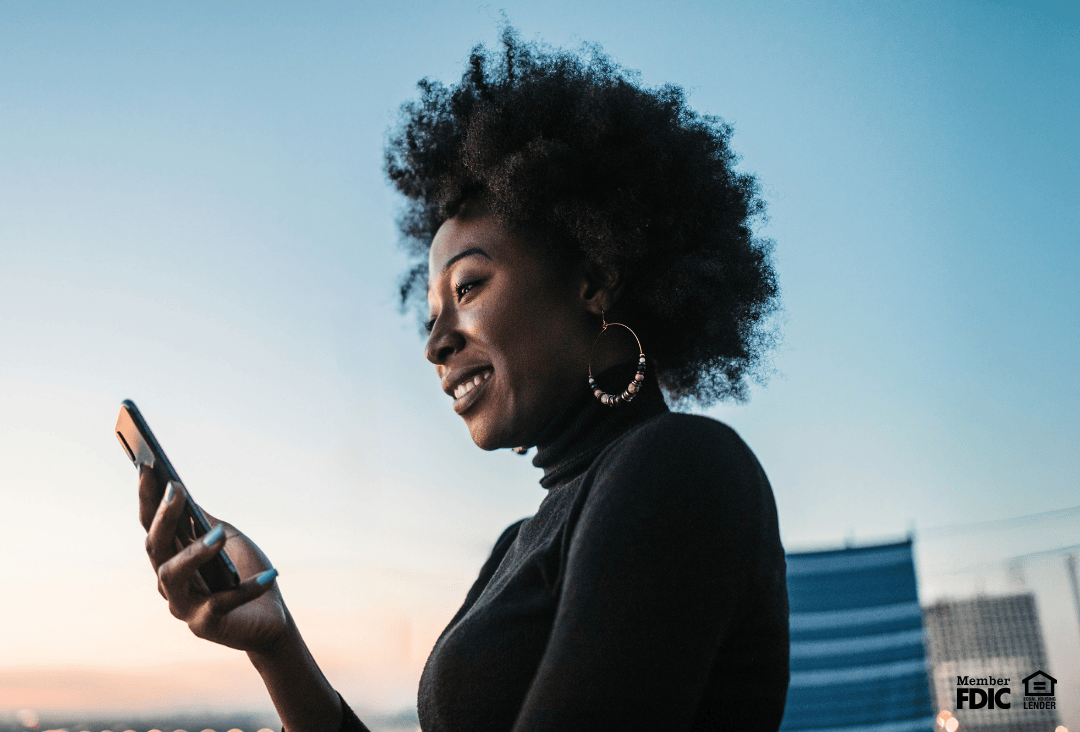 Woman using smartphone to compare hard inquiries and soft inquiries for credit.