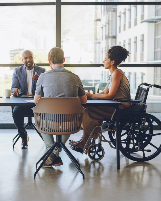 business woman in a wheelchair attends a done deal business meeting