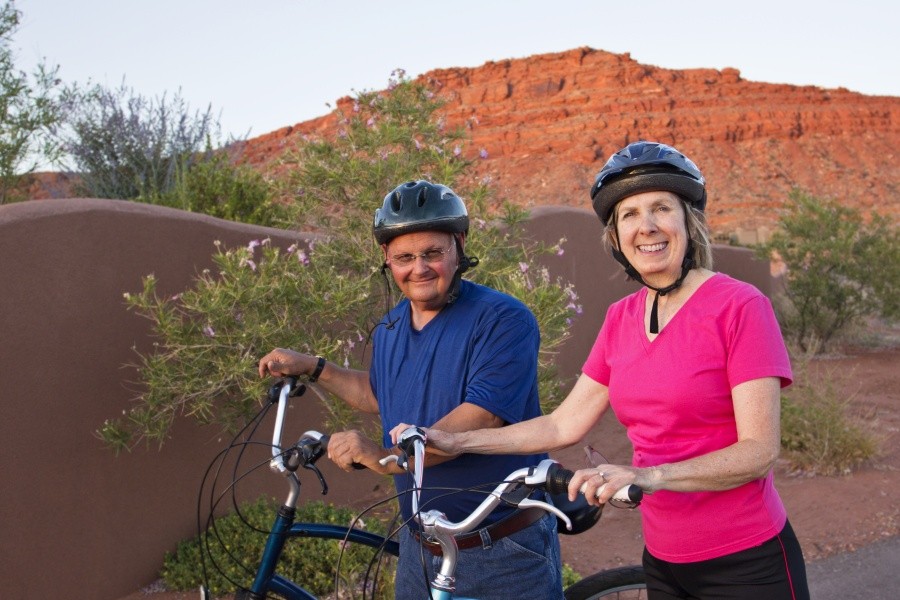 Academy Bank CD clients riding bikes toward savings