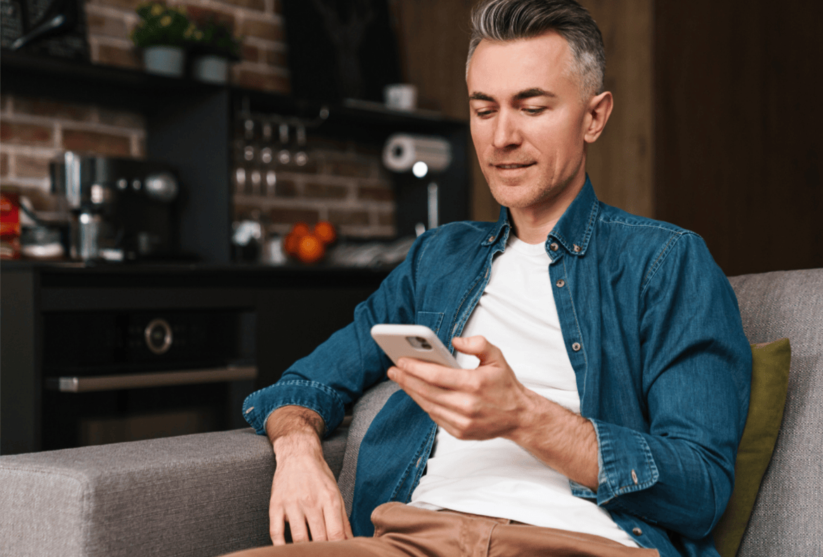 Middle aged man on his phone, hoping to avoid a payment app scam