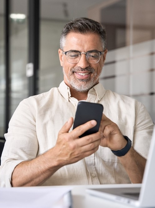 a businessman checks his email on his phone