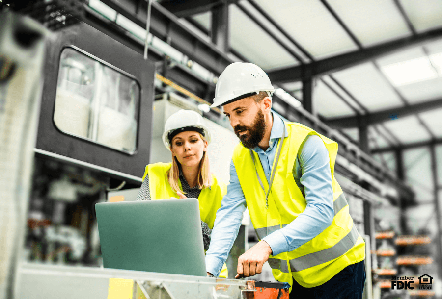 photo of two employees working in a factory setting