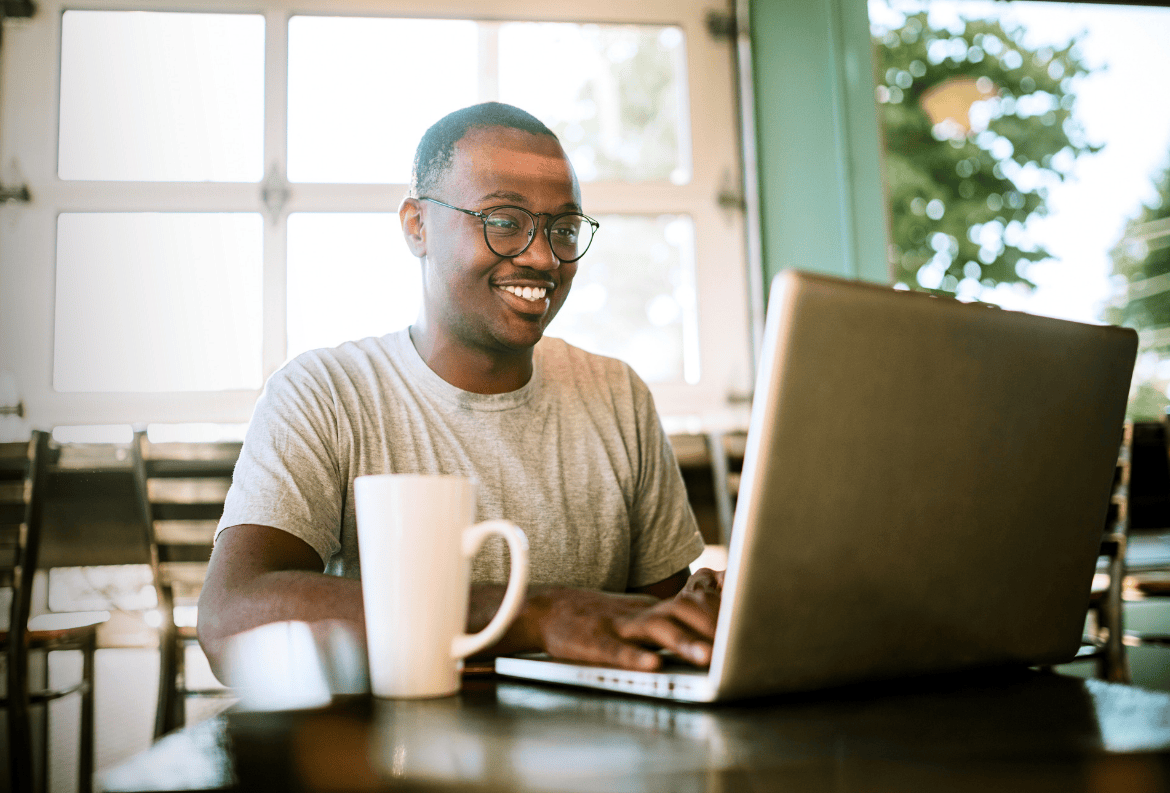 Man researching all of his amazing checking account rewards from Academy Bank.